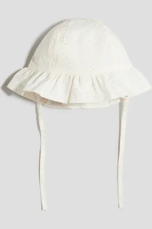 H&M Solhat i broderie anglaise af bomuld